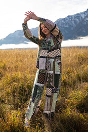 A model wearing the Vetiver Patchwork Shirt in colour Patchwork (Green), from the front, showing the whole outfit