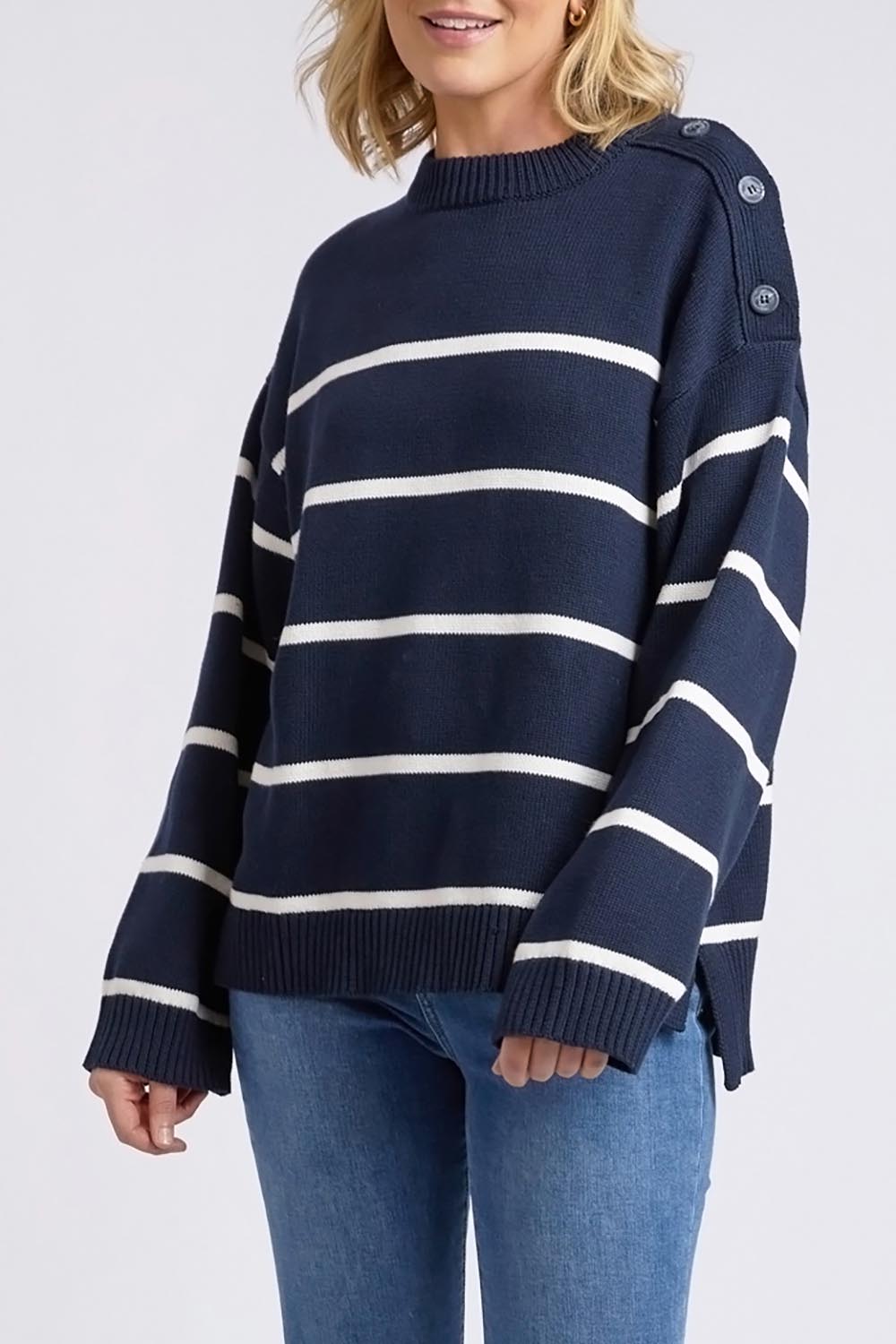 A model wearing the Iris Stripe Knit in colour Navywhite (Blue), from the front, cropped image