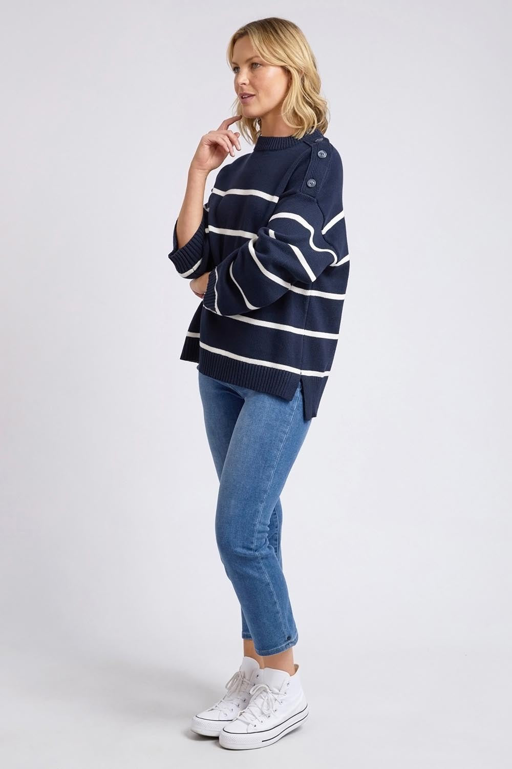 A model wearing the Iris Stripe Knit in colour Navywhite (Blue), from the front, showing the whole outfit