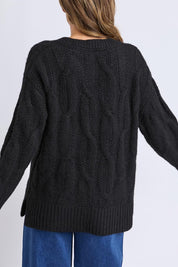 A model wearing the Tallulah Cable Knit in colour Black (Black), from the back