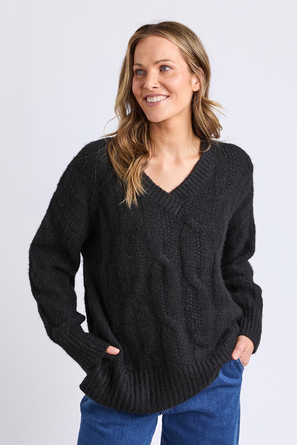 A model wearing the Tallulah Cable Knit in colour Black (Black), from the front, cropped image