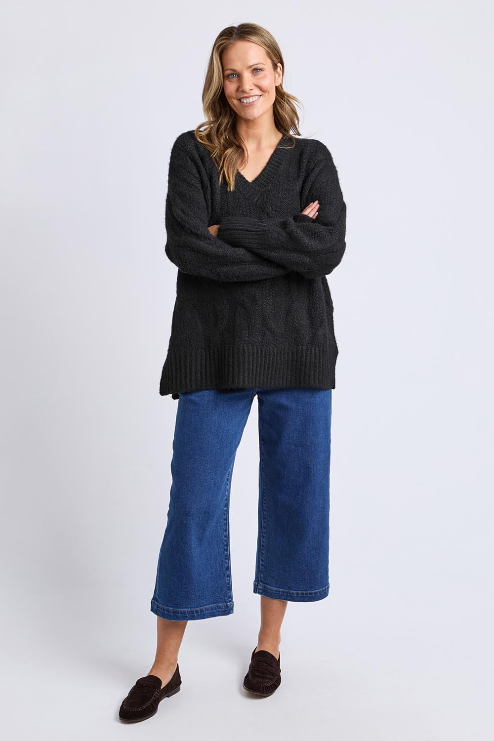 A model wearing the Tallulah Cable Knit in colour Black (Black), from the front, showing the whole outfit