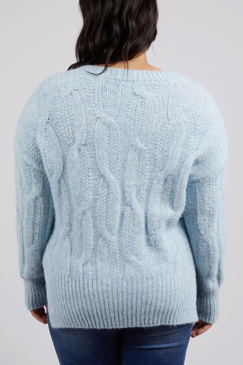 A model wearing the Tallulah Cable Knit in colour Bluemist (Blue), from the back
