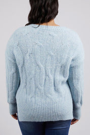 A model wearing the Tallulah Cable Knit in colour Bluemist (Blue), from the back