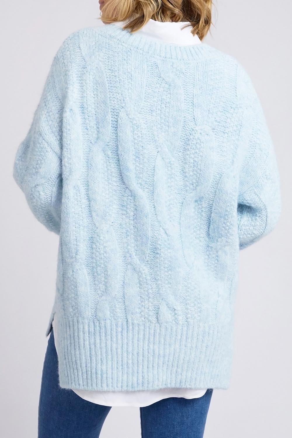 A model wearing the Tallulah Cable Knit in colour Bluemist (Blue), from the back