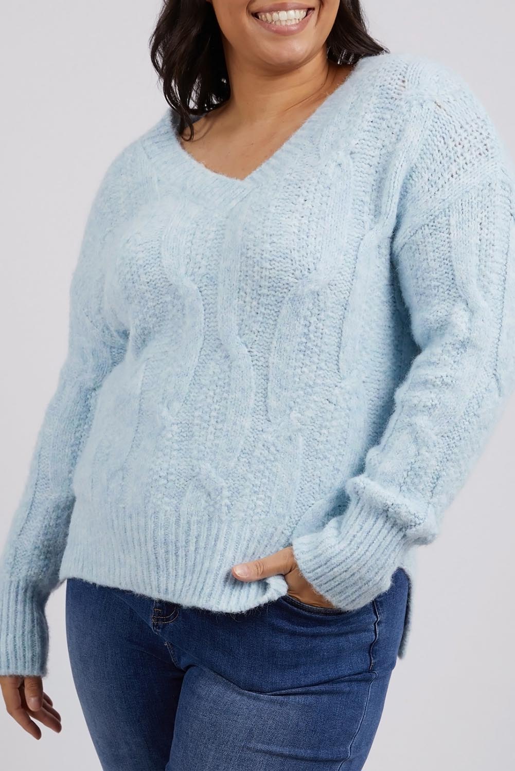 A model wearing the Tallulah Cable Knit in colour Bluemist (Blue), from the front, cropped image