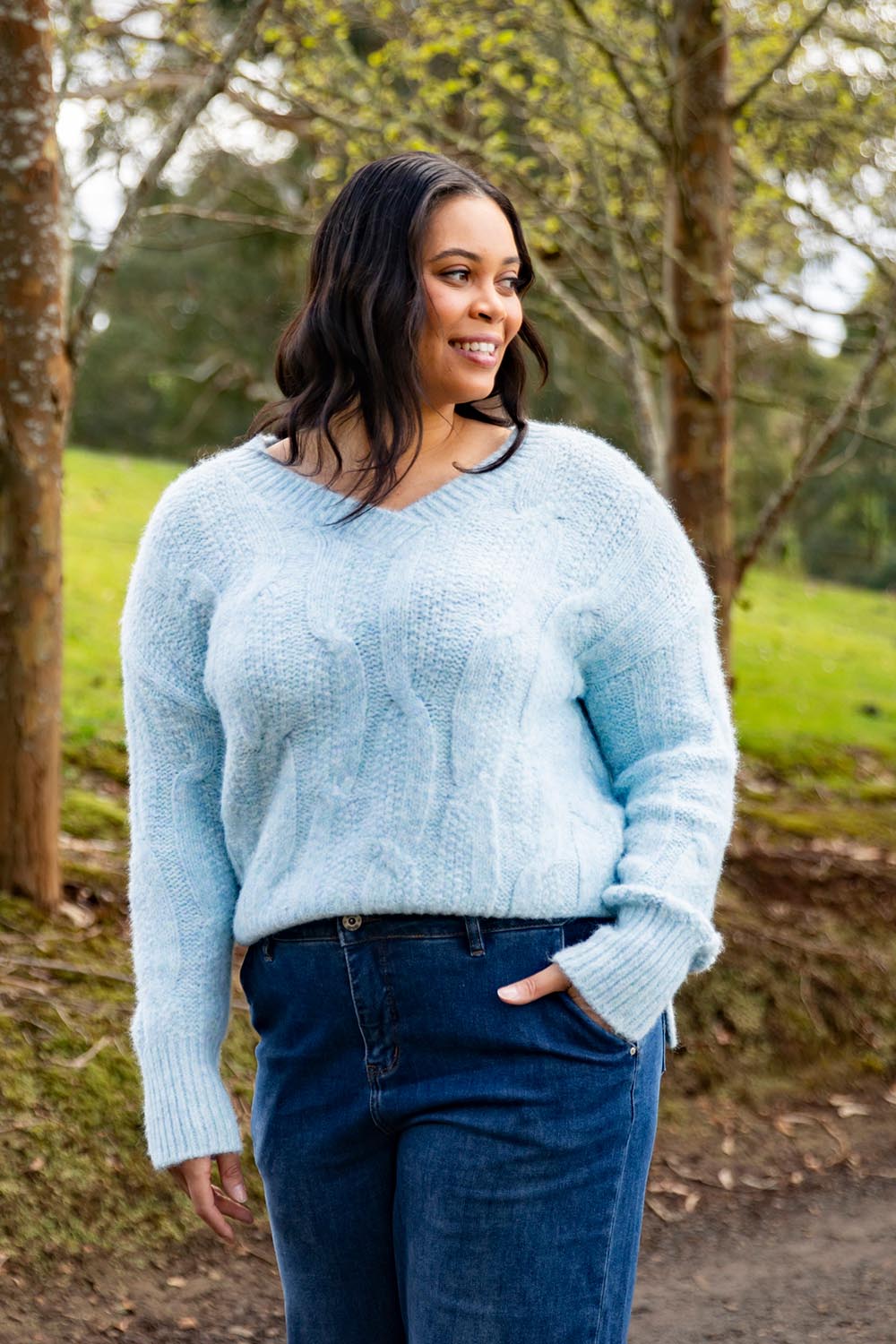 A model wearing the Tallulah Cable Knit in colour Bluemist (Blue), from the front, showing the whole outfit