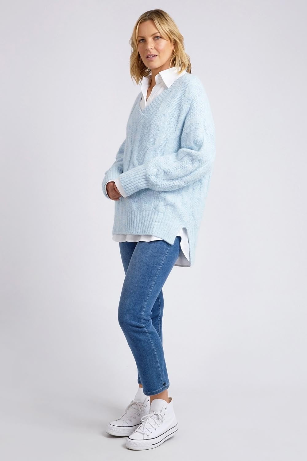 A model wearing the Tallulah Cable Knit in colour Bluemist (Blue), from the front, showing the whole outfit