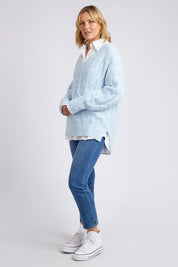 A model wearing the Tallulah Cable Knit in colour Bluemist (Blue), from the front, showing the whole outfit