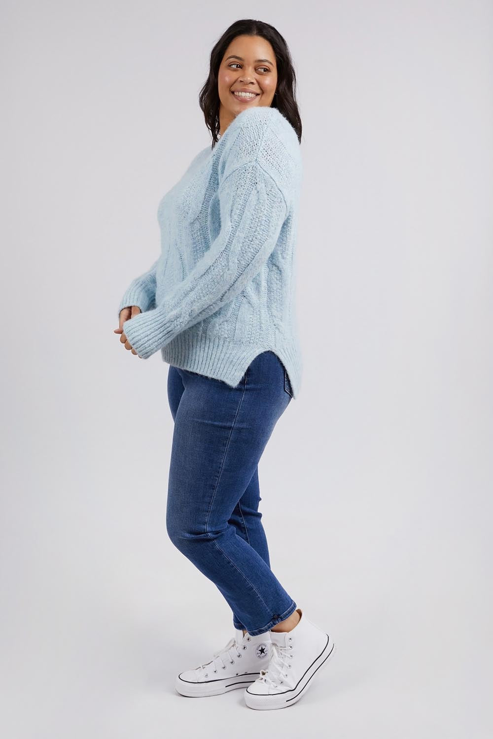 A model wearing the Tallulah Cable Knit in colour Bluemist (Blue), from the front, showing the whole outfit