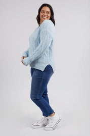 A model wearing the Tallulah Cable Knit in colour Bluemist (Blue), from the front, showing the whole outfit