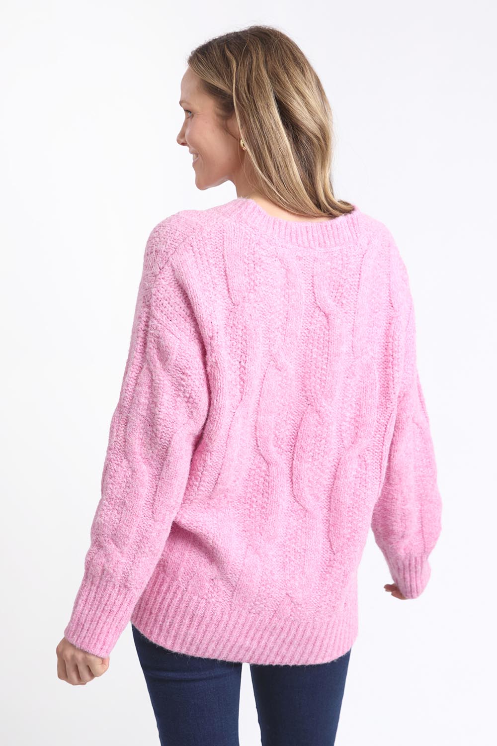 A model wearing the Tallulah Cable Knit in colour Pinkger (Pink), from the back