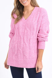 A model wearing the Tallulah Cable Knit in colour Pinkger (Pink), from the front, cropped image