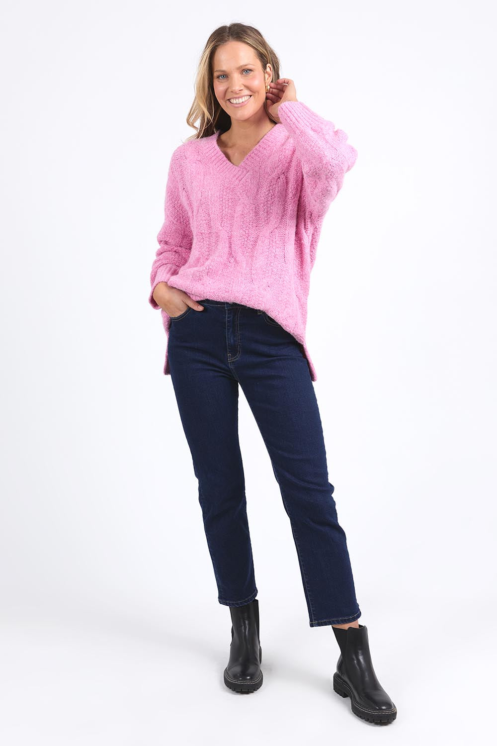 A model wearing the Tallulah Cable Knit in colour Pinkger (Pink), from the front, showing the whole outfit