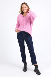 A model wearing the Tallulah Cable Knit in colour Pinkger (Pink), from the front, showing the whole outfit