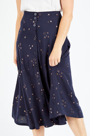 Model Shadae wearing size 10 of the Celestial Skirt in colour Navy (Blue), from the front, cropped image
