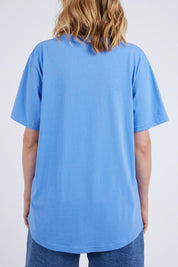 A model wearing the Holiday Sun Tee in colour Cerulean (Blue), from the back