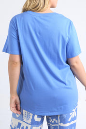 A model wearing the Holiday Sun Tee in colour Cerulean (Blue), from the back
