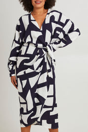 Model Olivia wearing size 10 of the Dali Abstract Dress in colour Midnight (Blue), from the front, cropped image