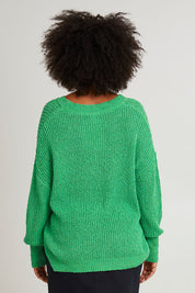 Model Olivia wearing size S of the Rachele V Neck Knit in colour Greenbriar (Green), from the back