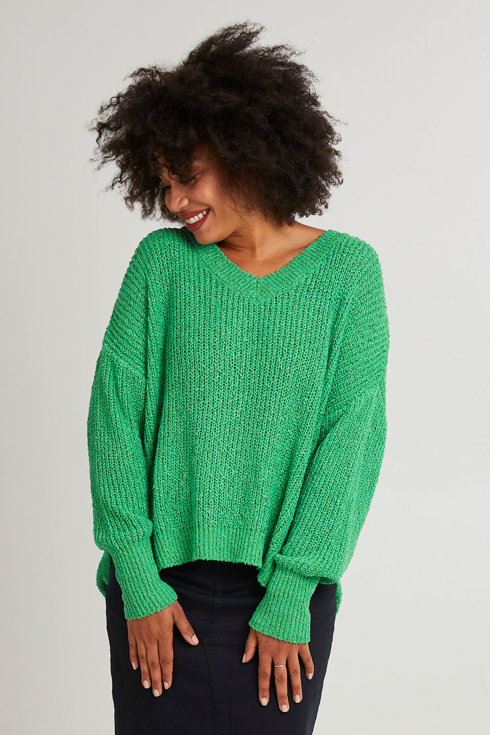 Model Olivia wearing size S of the Rachele V Neck Knit in colour Greenbriar (Green), from the front, cropped image