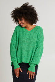 Model Olivia wearing size S of the Rachele V Neck Knit in colour Greenbriar (Green), from the front, cropped image