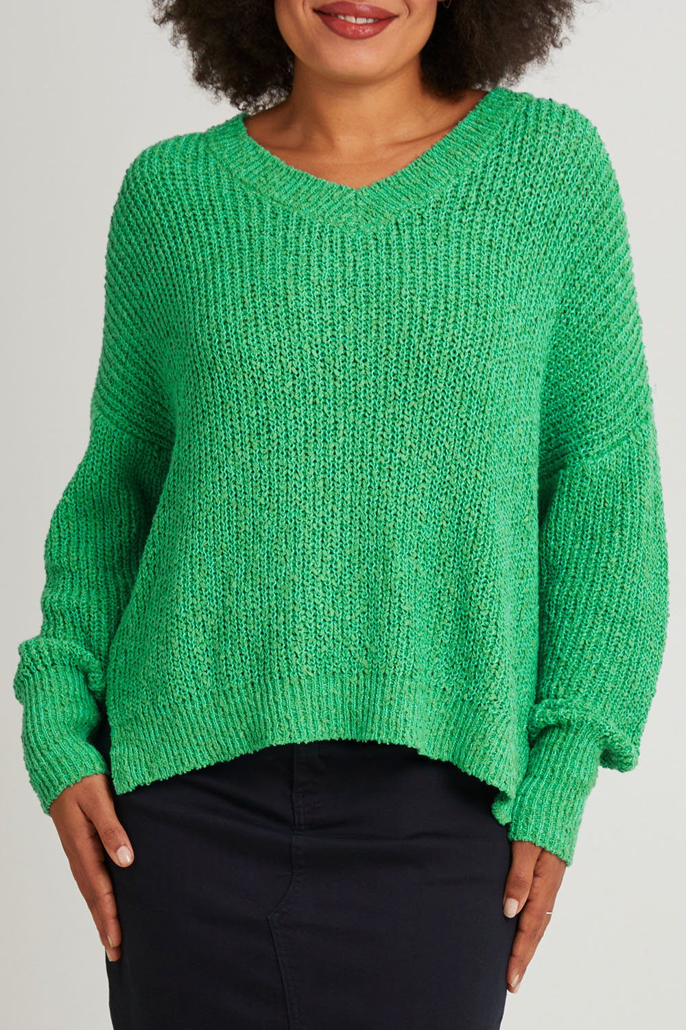 Model Olivia wearing size S of the Rachele V Neck Knit in colour Greenbriar (Green), from the front, cropped image
