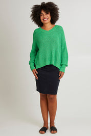 Model Olivia wearing size S of the Rachele V Neck Knit in colour Greenbriar (Green), from the front, showing the whole outfit