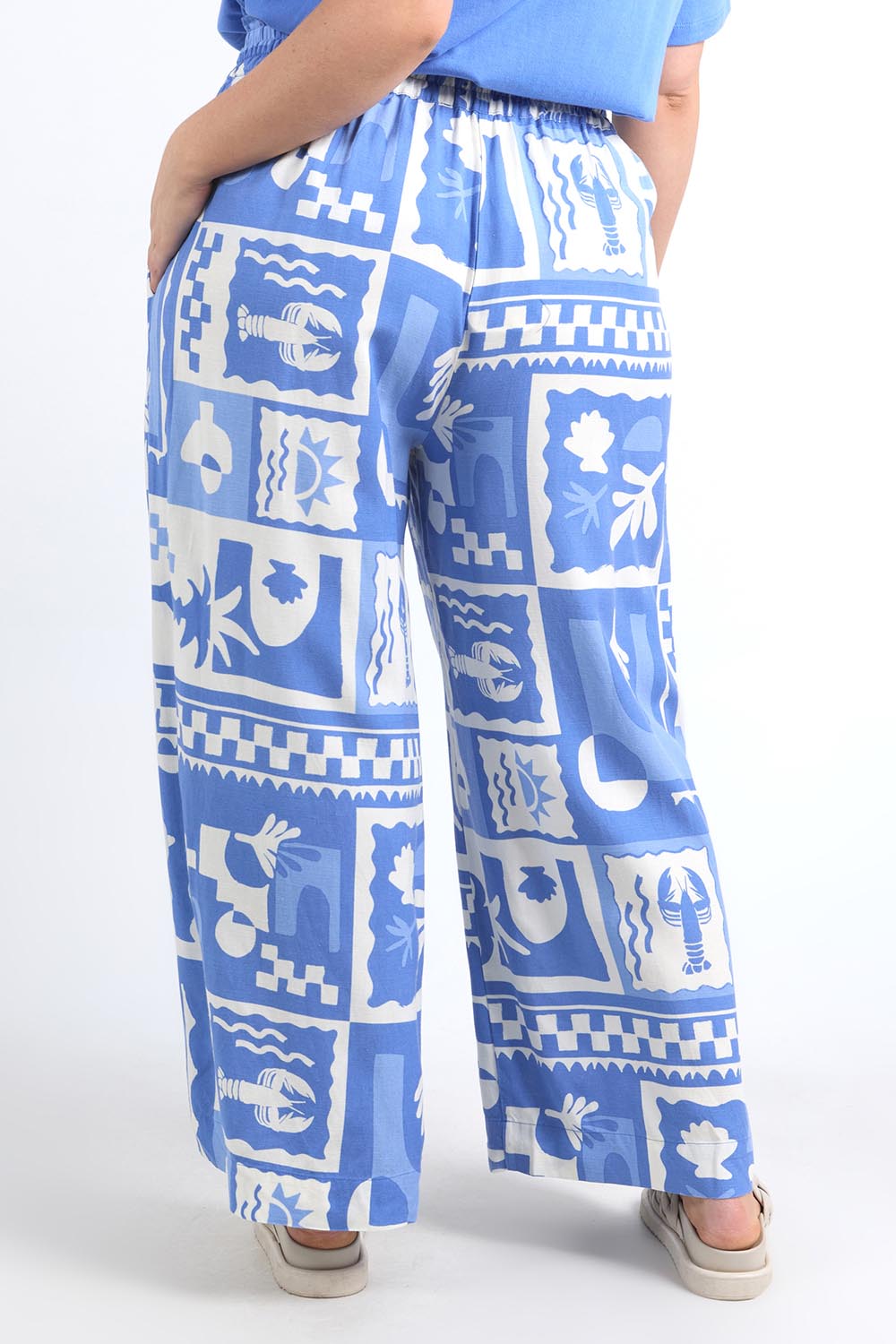 A model wearing the Holiday Sun Pant in colour Cerulean (Blue), from the back