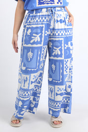 A model wearing the Holiday Sun Pant in colour Cerulean (Blue), from the front, cropped image