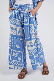 A model wearing the Holiday Sun Pant in colour Cerulean (Blue), from the front, cropped image