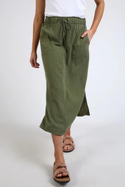 A model wearing the Mila Utility Skirt in colour Clover (Green), from the front, cropped image
