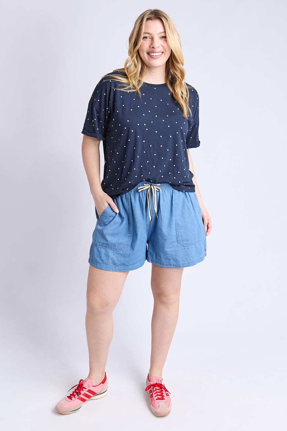 A model wearing the Festive Spot Cotton Blend Tee in colour Navy (Blue), from the front, showing the whole outfit