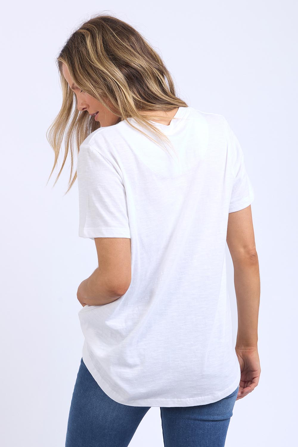 A model wearing the Line Up Tee in colour Marshmello (White), from the back