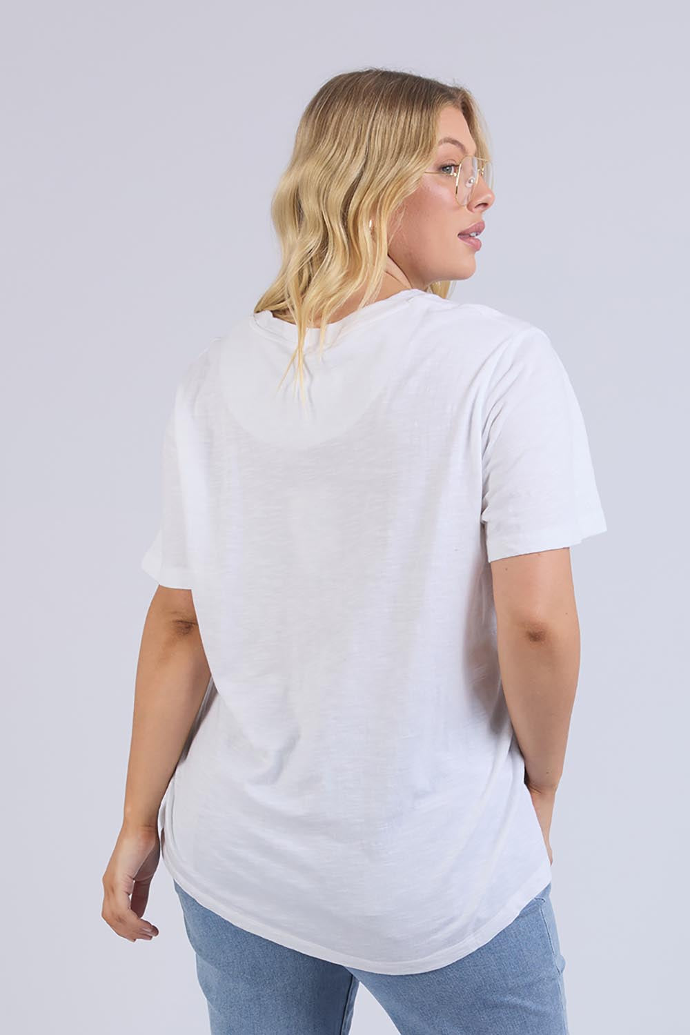 A model wearing the Line Up Tee in colour Marshmello (White), from the back
