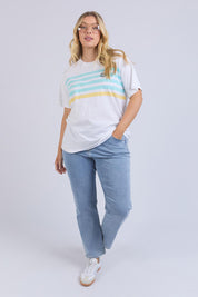 A model wearing the Line Up Tee in colour Marshmello (White), from the front, showing the whole outfit