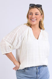 A model wearing the Isabella Cotton Blend Blouse in colour Marshmello, from the front, cropped image