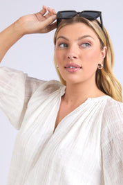 A model wearing the Isabella Cotton Blend Blouse in colour Marshmello, from the front, cropped image