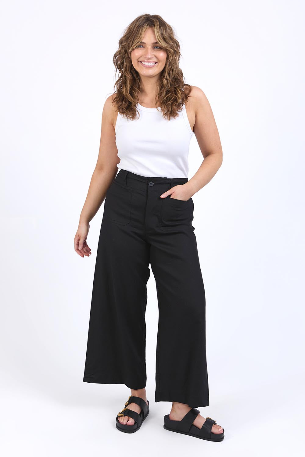 A model wearing the Wendy Pant in colour Black (Black), from the front, showing the whole outfit