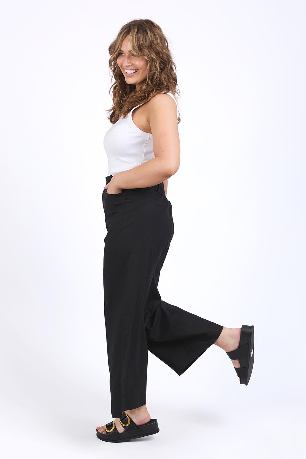 A model wearing the Wendy Pant in colour Black (Black), from the front, showing the whole outfit