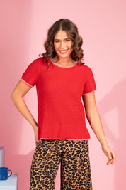 A model wearing the Camellia Short Sleeve Cotton Knit in colour Cranberry (Red), from the front, showing the whole outfit