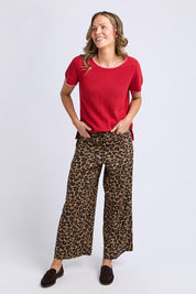 A model wearing the Camellia Short Sleeve Cotton Knit in colour Cranberry (Red), from the front, showing the whole outfit