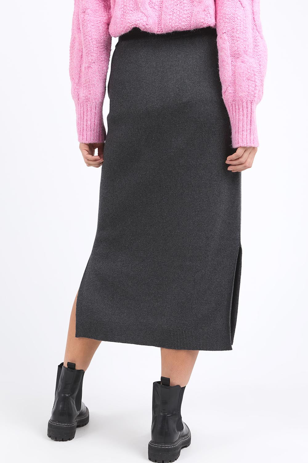 A model wearing the Elodie Cotton Blend Knit Skirt in colour Charcoal (Grey), from the back