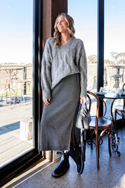 A model wearing the Elodie Cotton Blend Knit Skirt in colour Charcoal (Grey), from the front, showing the whole outfit