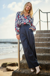 Model Maggie wearing size 10 of the Darcy Tencel Cotton Pant in colour Darksapphi (Blue), from the front, showing the whole outfit