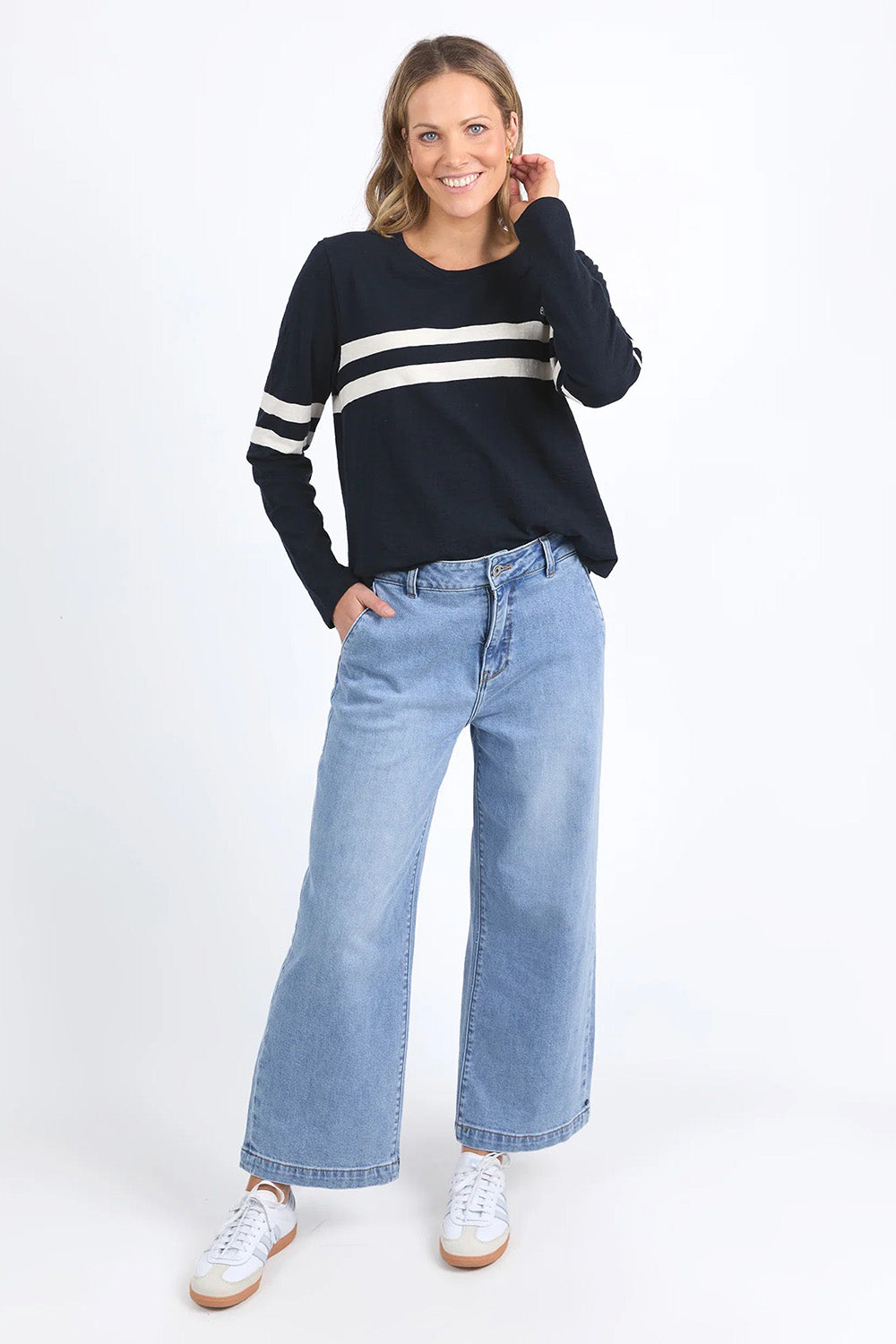 A model wearing the Adora Long Sleeve Cotton Tee in colour Darksapph (Blue), from the front, showing the whole outfit