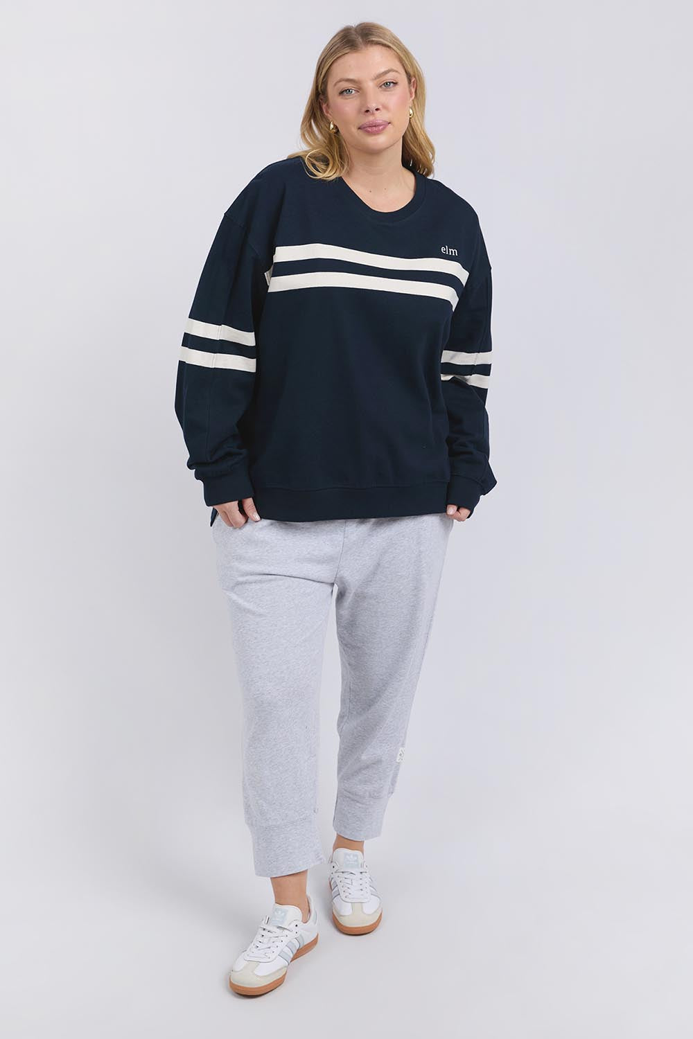 A model wearing the Adora Cotton Blend Crew in colour Drksapphir (Blue), from the front, showing the whole outfit
