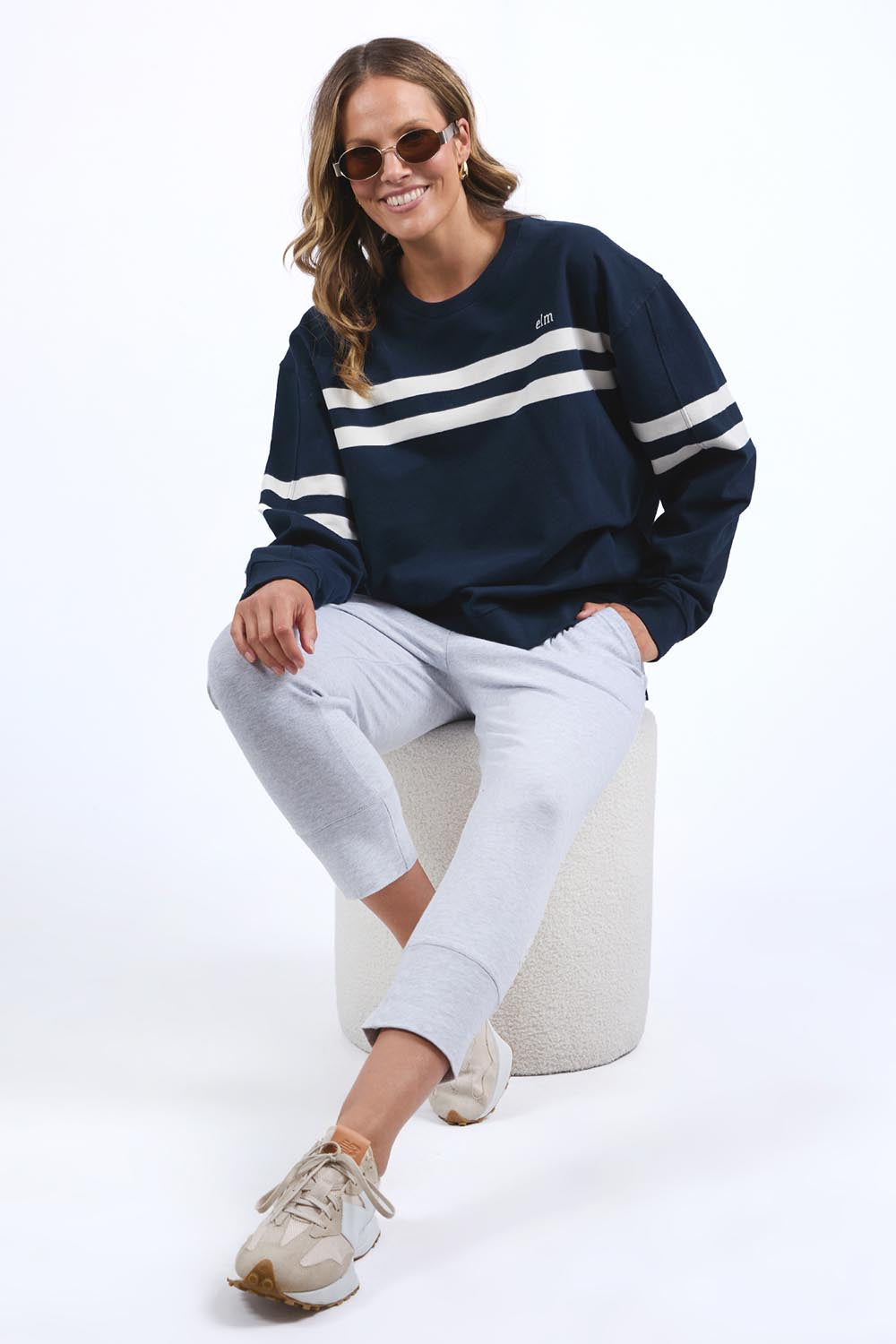 A model wearing the Adora Cotton Blend Crew in colour Drksapphir (Blue), from the front, showing the whole outfit