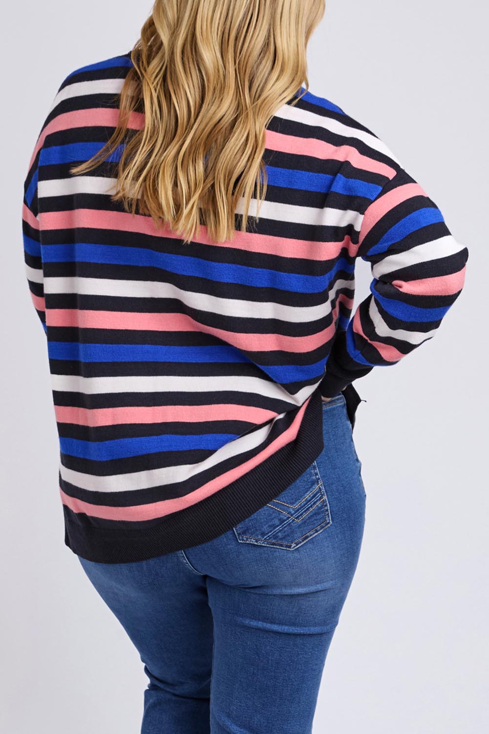 A model wearing the Logan Stripe Knit in colour Navy (Blue), from the back