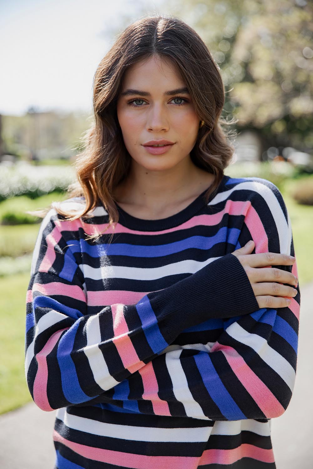 A model wearing the Logan Stripe Knit in colour Navy (Blue), from the front, cropped image